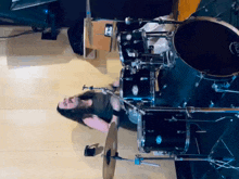 a man is playing a drum set with a drum that says ' king ' on it