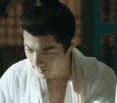 a man with a bun on his head looks down