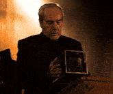 a man in a suit is holding a glass cube in his hand