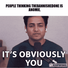 a man in front of a microphone with the words it 's obviously you