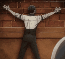 a man is leaning against a wall with his arms outstretched