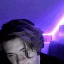 a man with a purple light behind him