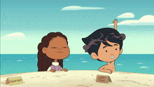 a boy and a girl are sitting on a sandy beach with a sign that says larry town