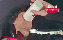 a man drinking from a cup with the words good morning written on the bottom