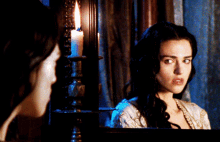 a woman looking at her reflection in a mirror