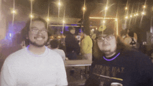 a man wearing a shirt that says spray hat is standing next to another man