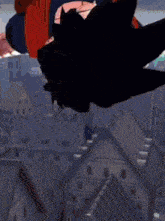 a close up of a person covering their mouth with their hands .