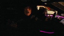 a man in a hooded jacket sits on the stairs