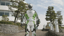 a person in a green and white costume with a target on his chest