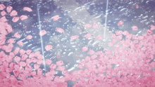 a bunch of pink flowers falling into the water