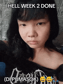 a girl is wearing a black shirt with the words hell week 2 done