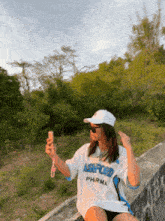 a woman wearing a white ashford shirt is taking a selfie