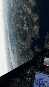 a view of the earth from the cockpit of a plane with wc written on it