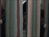 a man in a black coat is running through a mirrored room