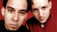 two men are standing next to each other with one wearing a red jacket with the letter c on the zipper