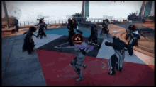 a group of people are playing a video game and one has a pumpkin on his head