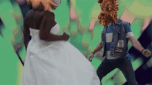 a woman in a white dress is dancing with a man with a dog mask on