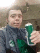 a man holding a green can with a shamrock on it