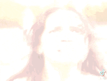 a close up of a woman 's face with a blurred background .
