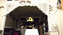 a person in a pac man costume is dancing in a room