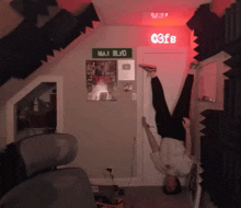 a man is doing a handstand in front of a max blvd sign