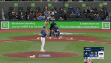 a baseball game is being played in front of a banner that says business banking curve balls