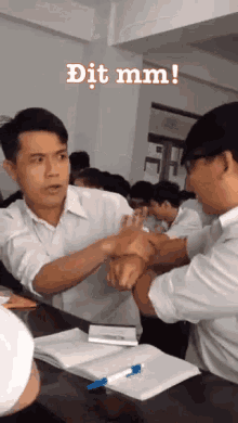 two men are fighting in a classroom with the words dit mm written on the bottom