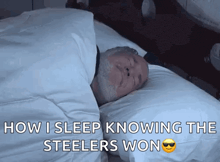 a man is sleeping in a bed with the words " now i sleep knowing the steelers won " on the bottom