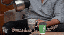 a man is pouring coffee into a cup with the words drowning in nasha written on the bottom