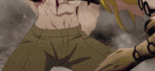 a man with a bloody chest is being held by a woman with gold gloves .