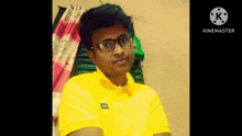 a man wearing glasses and a yellow shirt has a watermark that says kinemaster