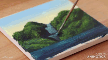 a painting of a waterfall is being painted on a canvas by chloe art