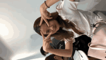 a woman making a peace sign with her fingers