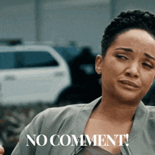 a woman with a sad look on her face and the words no comment