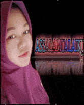 a woman wearing a purple hijab is standing in front of a sign that says " assalamualaikum "