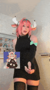 a girl with pink hair and horns is wearing a black sweater dress