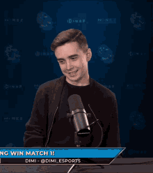 a young man stands in front of a microphone with the words " king win match 1 " on the bottom