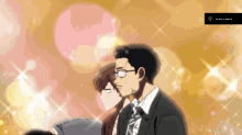 a man in a suit and tie stands next to a woman in a pink dress