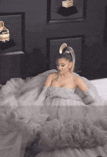 a woman in a white dress and gloves looks down