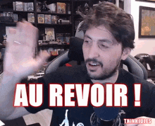 a man in a black shirt with the words au revoir on it