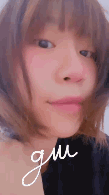 a close up of a woman 's face with the word gui written next to it