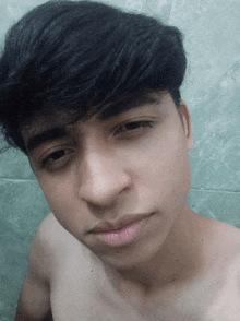 a young man without a shirt is taking a picture of himself