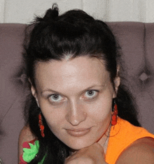 a close up of a woman 's face with a purple background