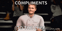 a man in a chef 's uniform is holding a piece of paper that says compliments to the chef on it