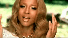 a close up of a woman 's face with her hands up .