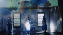 a group of people playing instruments in front of a window