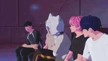 a group of young men are sitting in a room and one has a cat hat on