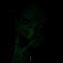 a close up of a person 's face in a dark room