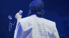 the back of a person wearing a white jacket that says ready to be on it