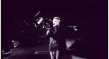 a man in a hockey mask is holding a bat in a black and white photo